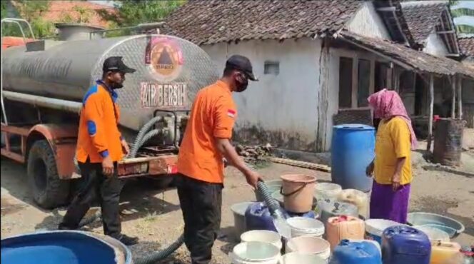 
					Petugas BPBD mengisi timba dan jeriken dengan air bersih.
