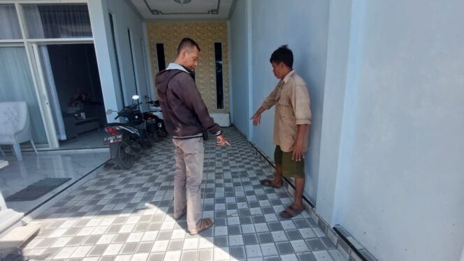 
					Budianto( berbaju krem) menunjukkan lokasi motor anaknya yang dicuri.