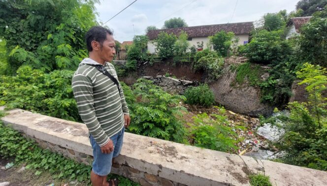 
					AMBROL: Slamet melihat plengsengan di aliran sungai Legundi Kota Probolinggo yang ambrol. (foto: Hafiz Rozani)
