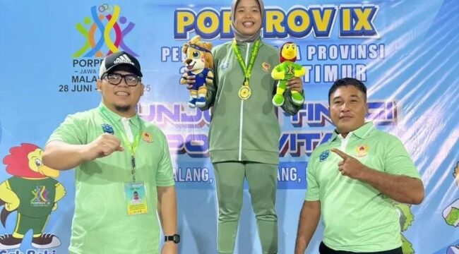 BERPRESTASI: Atlet Kick Boxing, Layla Ramadhani Yusgianti, diatas podium ditemani Wakil Ketua KONI Kab. Probolinggo, Gus Ahmad Syamsul Askandar. (foto: istimewa)..