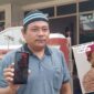 MENINGGAL: Anak pertama korban, Riki Putra menunjukkan foto ayahnya, Suryono (insert) yang meninggal dalam kecelakaan laut di Selat Bali. (foto: Hafiz Rozani).