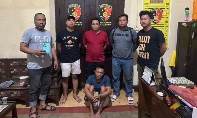 
					DITANGKAP: Nurahmad (duduk dengan memegang ponsel curiannya) usai diamankan oleh anggota Polsek Dringu, Polres Probolinggo. (foto: istimewa)