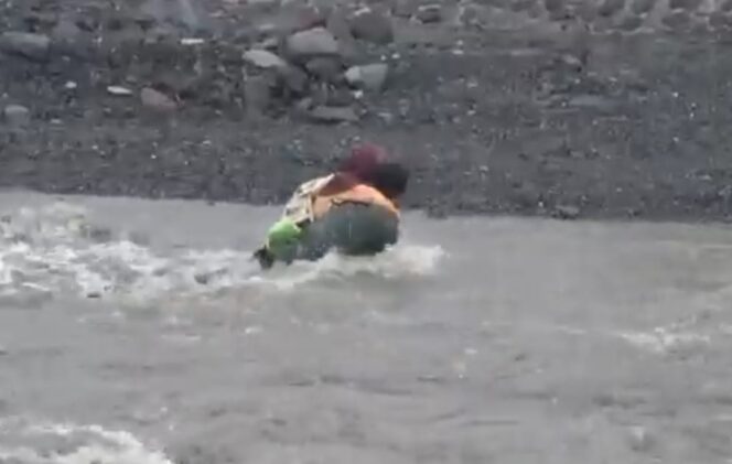 
					Seorang ayah yang menggendong anaknya terjatuh saat menyeberangi Sungai Regoyo. (Foto: tangkapan layar).
