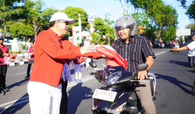 
					BERBAGI: Wali Kota Probolinggo, dr. Aminuddin, membagikan bendera merah putih kepada para pengguna jalan. (foto: istimewa)