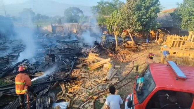 
					Petugas Damkar sedang memadamkan api yang membakar gudang mebel di Gondangwetan, Kabupaten Pasuruan. (Foto: Moh. Rois)