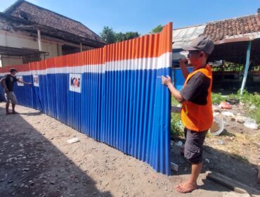 EKSEKUSI: Pemasangan penutup berupa seng di aset PT. KAI Daop 9 Jember di Jalan Suroyo, Kelurahan Tisnonegaran, Kec. Kanigaran, Kota Probolinggo. (Foto: Hafiz Rozani).
