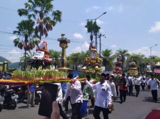 MERIAH: Warga membawa gunungan hasil bumi untuk disedekahkan kepada masyarakat setelah didoakan bersama, di Alun-alun Kota Jember. (Foto: M. Abd Rozaq Mubarok).